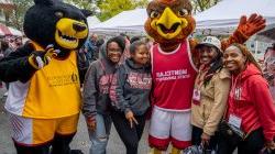 Mascots, Rocky and Deacon, taking a picture with students.